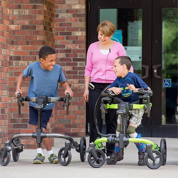 Two young boys with disabilities using the Rifton Pacer pediatric gait trainers