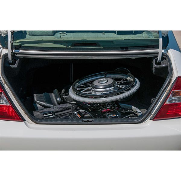 Sunrise Medical Quickie Xtender Electric Assist Wheelchair Accessory stored in the trunk of a car