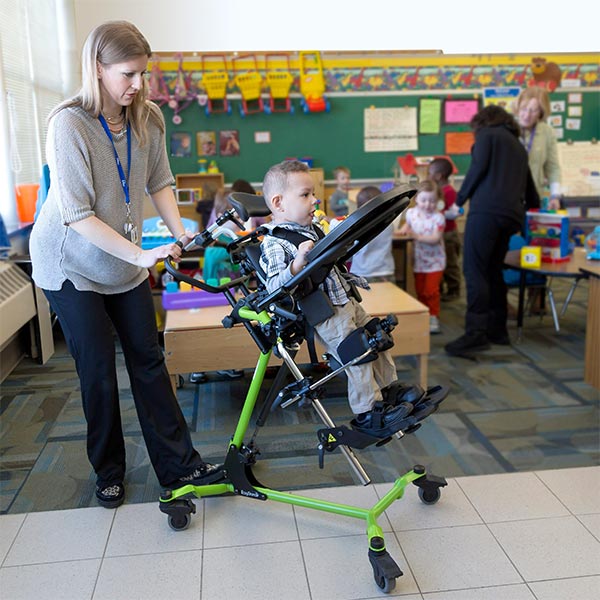 Zing Multi-Positional Pediatric Standing Frame being used by a teacher to care for a child with special needs.